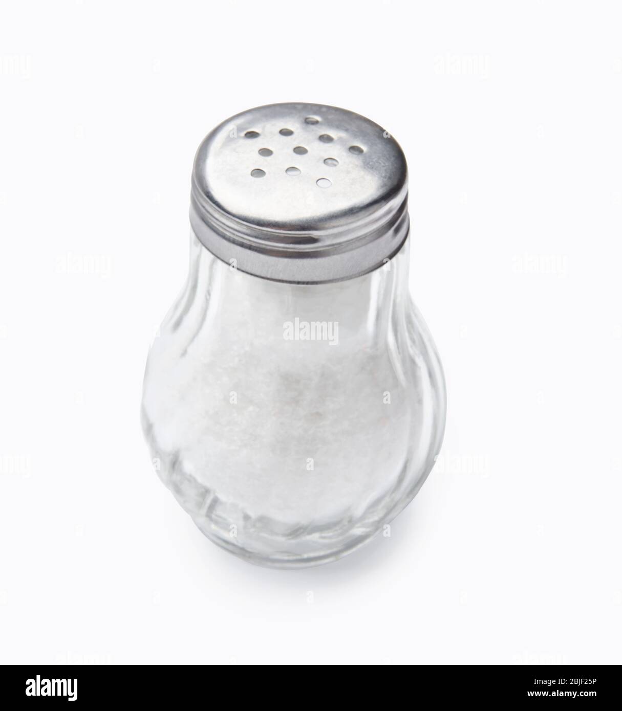 Salt shaker isolated on white background. Salt in glass bottle. Stock Photo