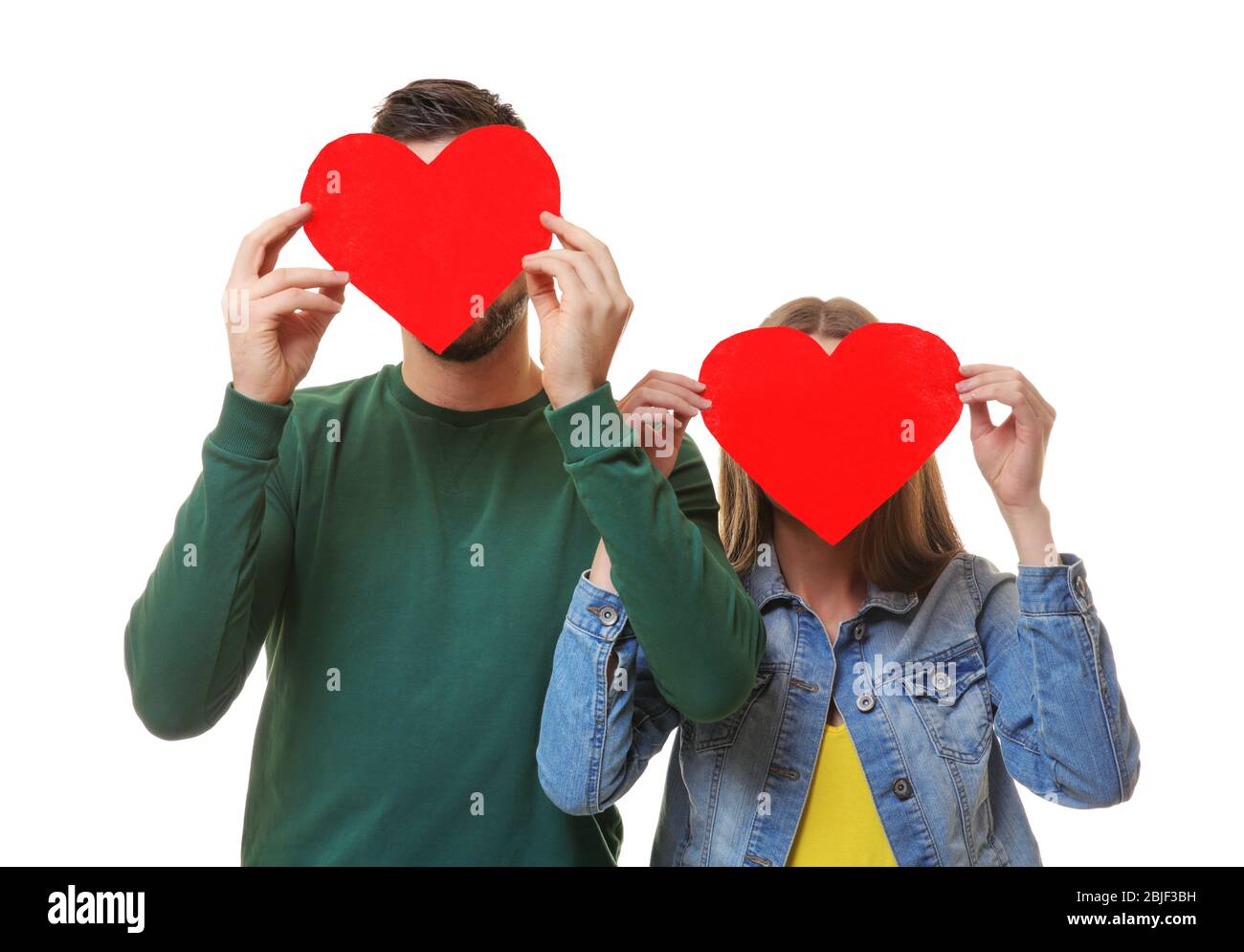 Happy young couple with red hearts on white background Stock Photo - Alamy