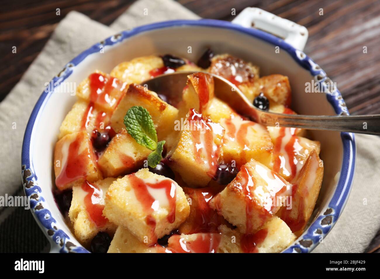 Delicious bread pudding with currant and jam in bowl Stock Photo