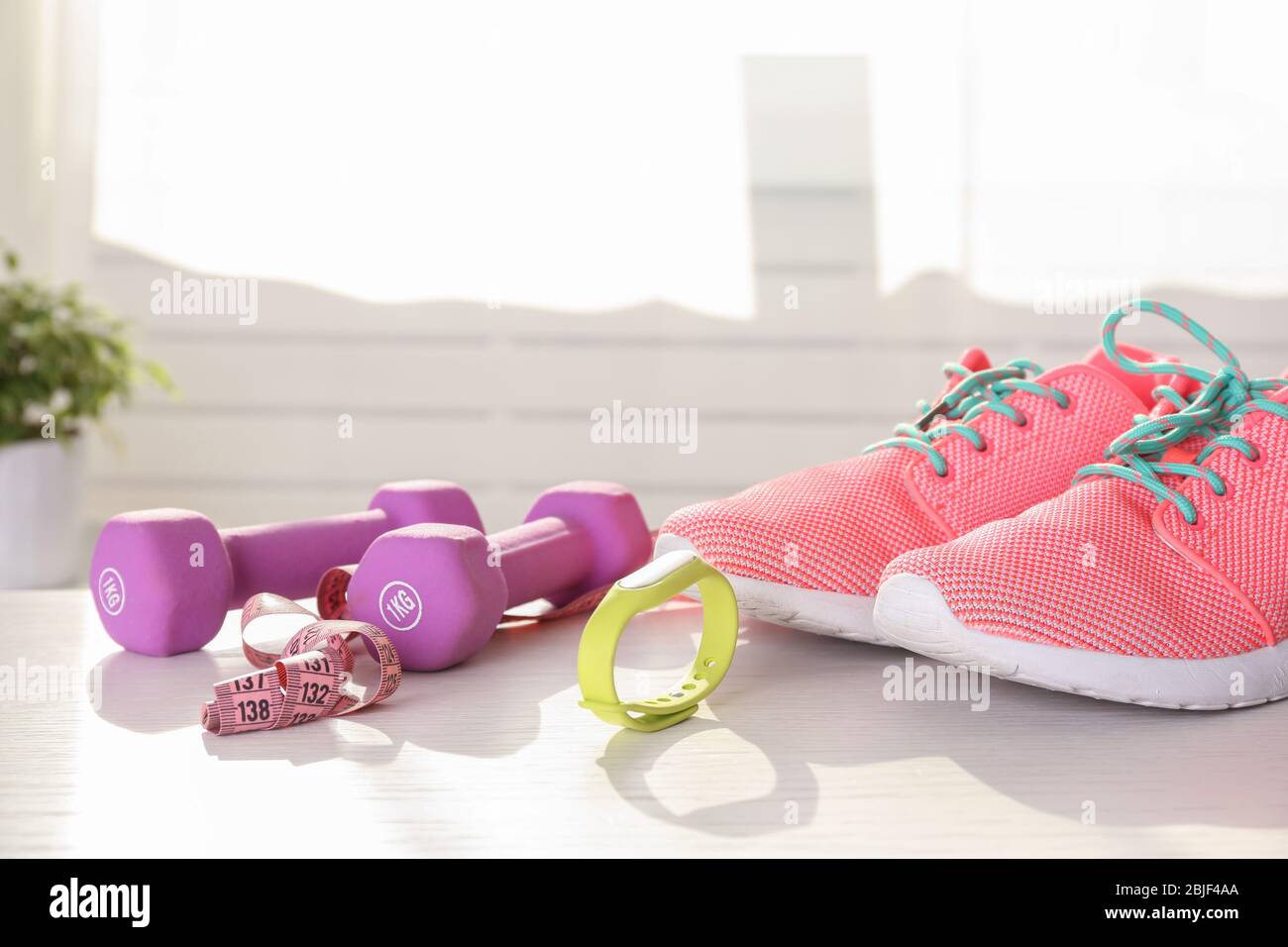 Sport stuff with fitness tracker on wooden table Stock Photo