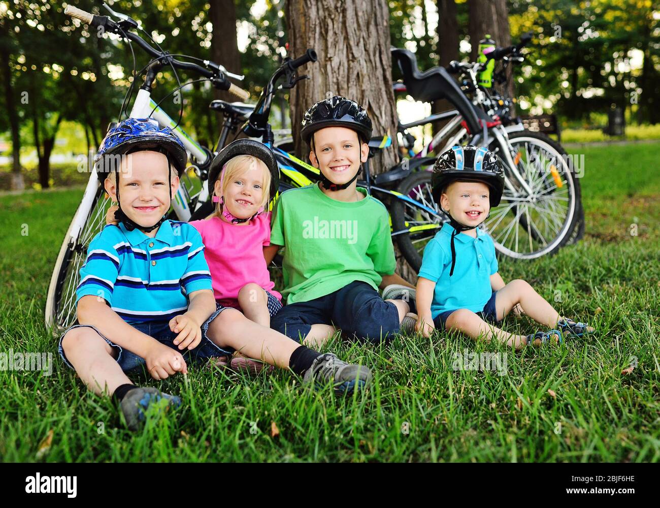 group of small preschool children in Bicycle safety helmets smile