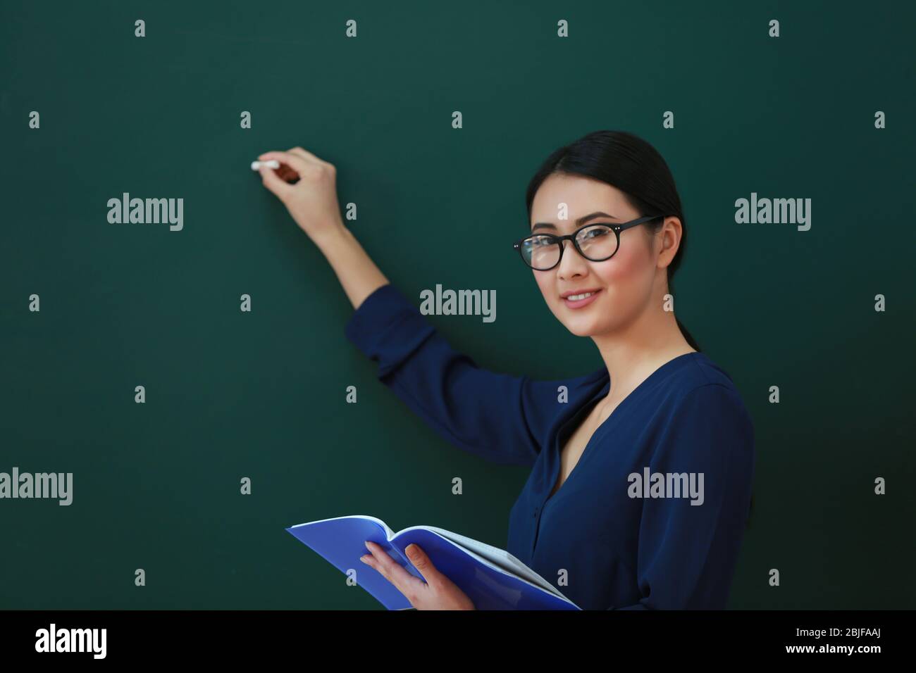 Portrait of Asian female teacher on blackboard background Stock Photo ...