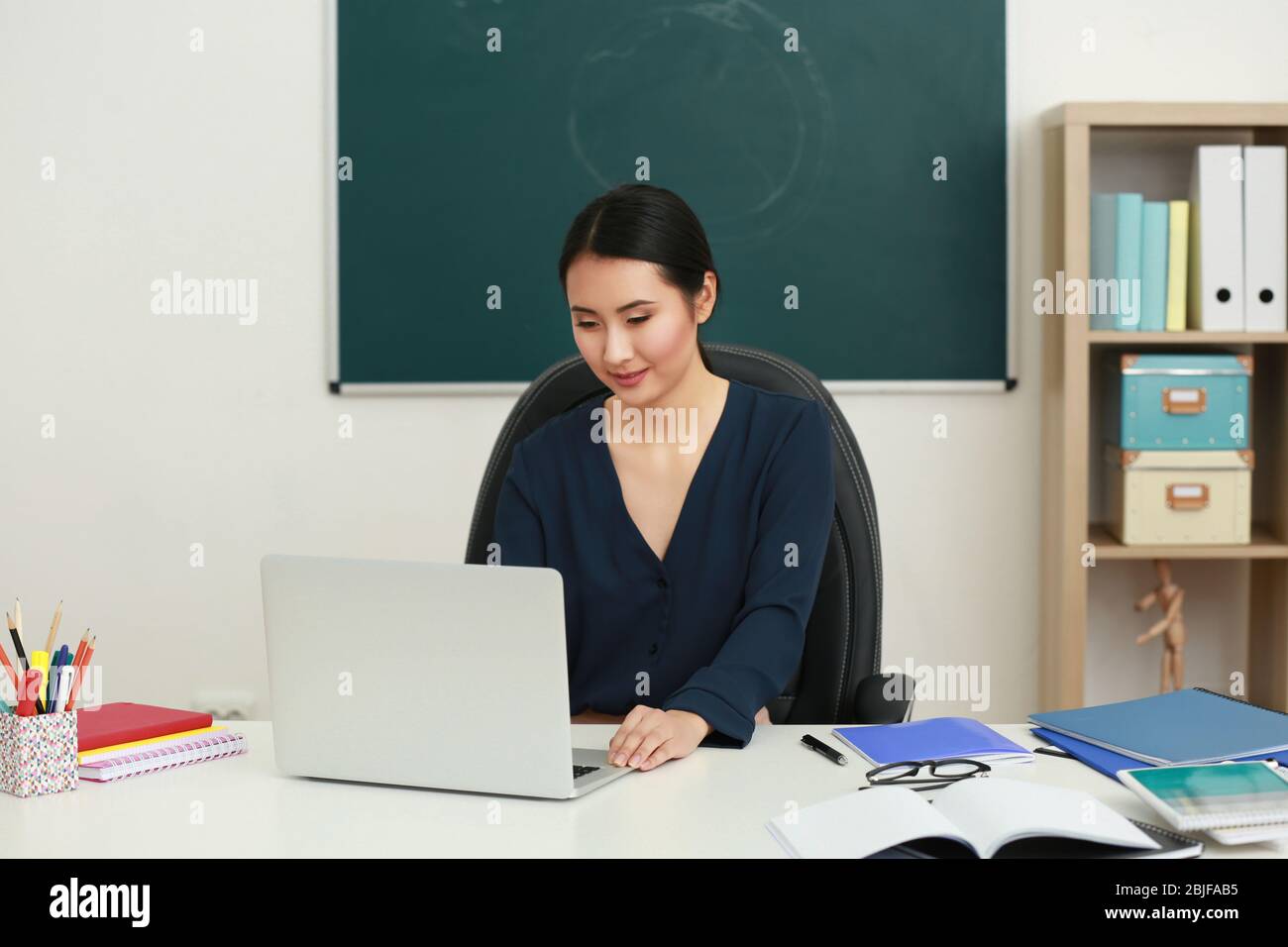 Portrait of Asian female teacher in classroom Stock Photo - Alamy