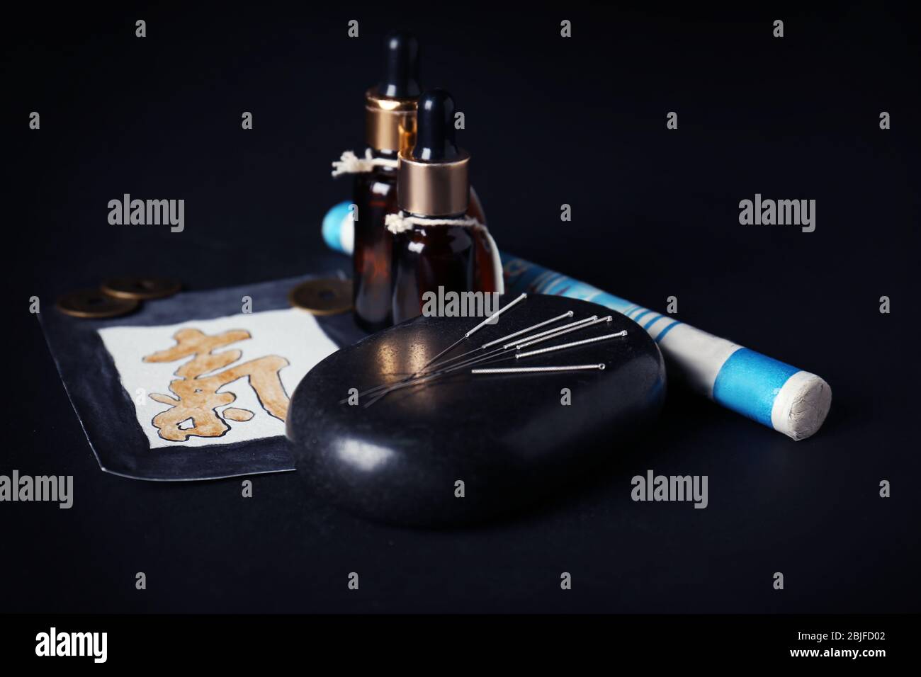 Acupuncture supplies on black background Stock Photo - Alamy