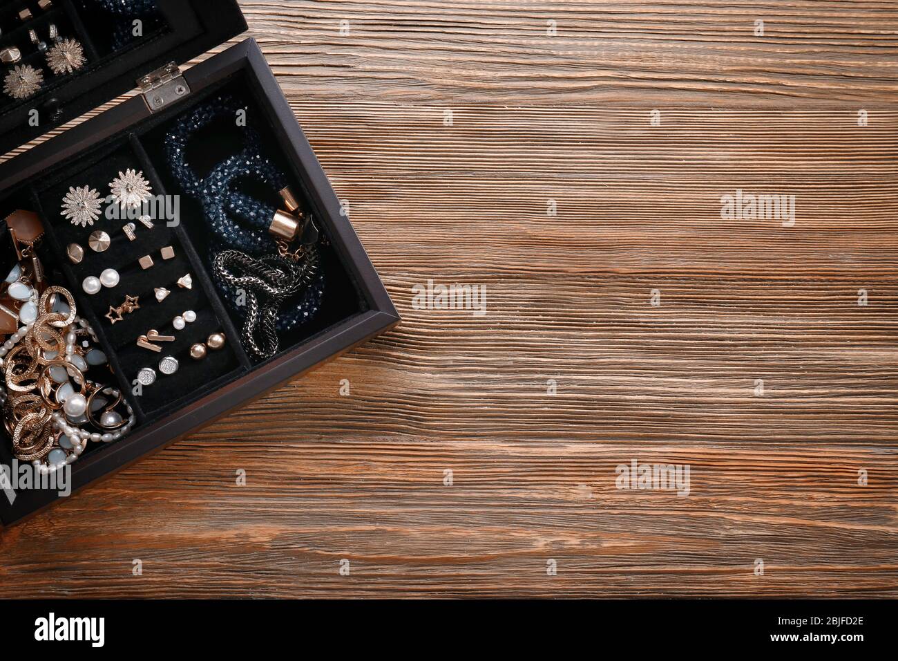 Jewelry in box on wooden background Stock Photo - Alamy