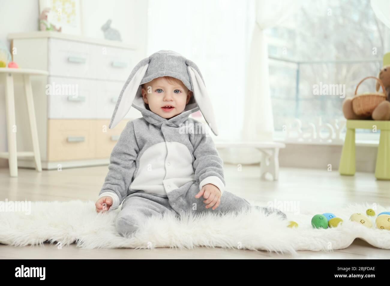 Cute little baby in bunny costume playing at home Stock Photo Alamy