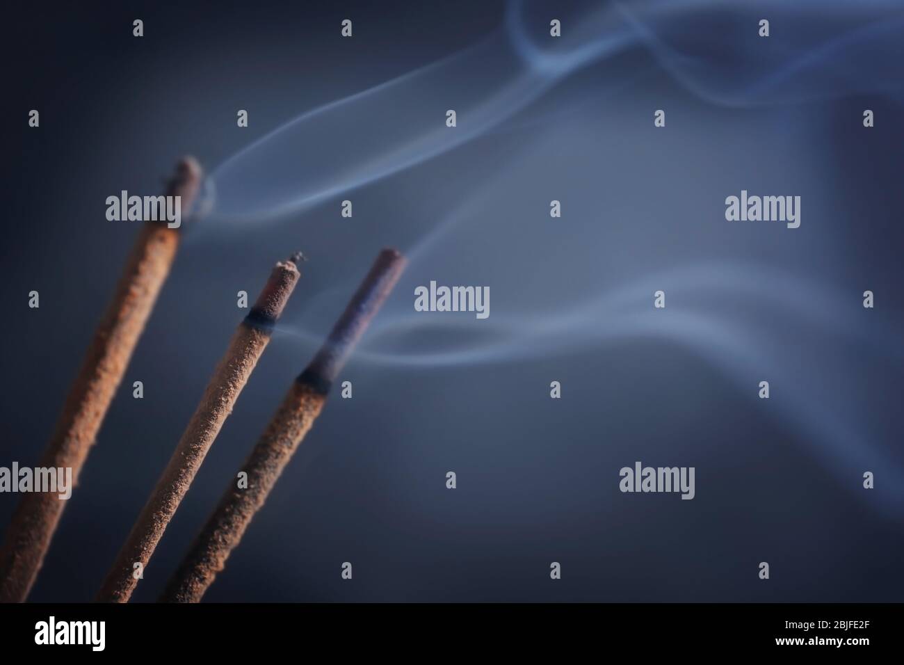 Aroma sticks with smoke Stock Photo - Alamy