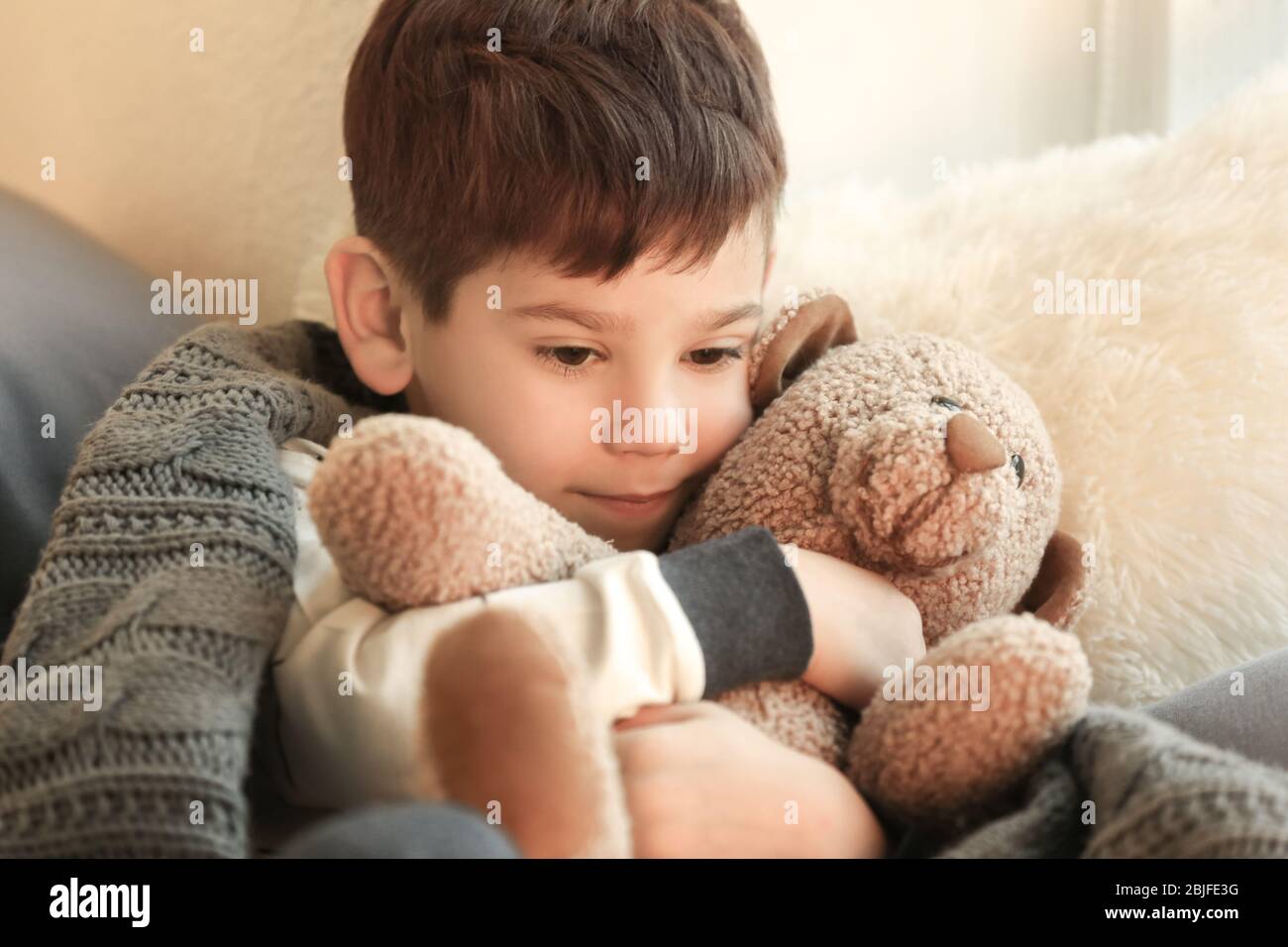 Cute little boy with teddy bear at home Stock Photo - Alamy