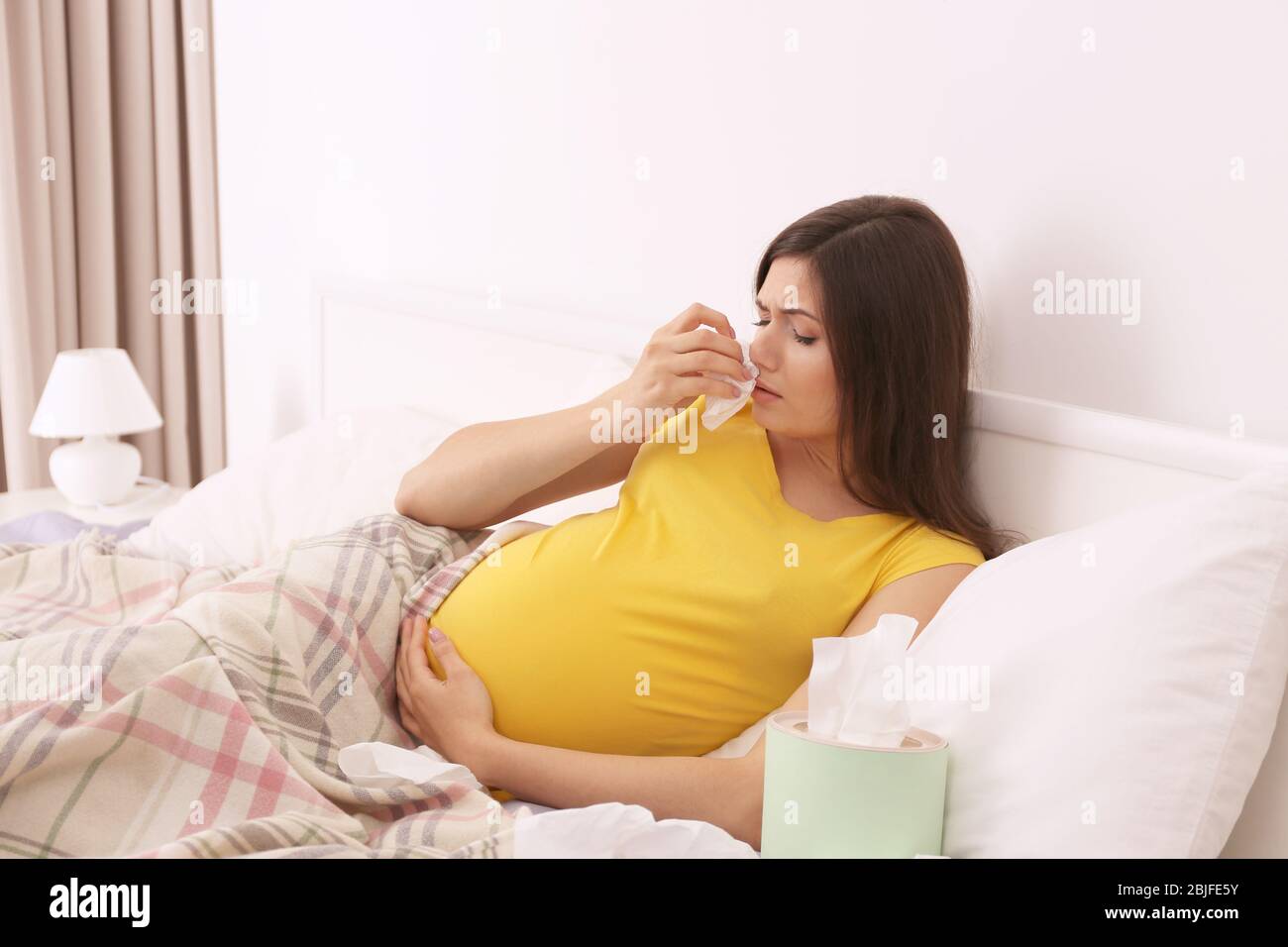 Pregnant woman with allergy in bed at home Stock Photo Alamy