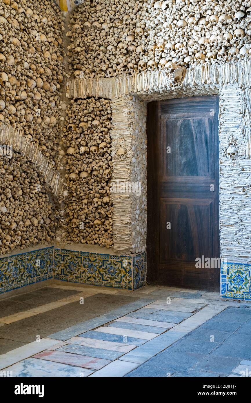 Thousands of human skulls and bones in Chapel of Bones - Capela dos Ossos - in Church of Saint Francis, Evora, Portugal Stock Photo