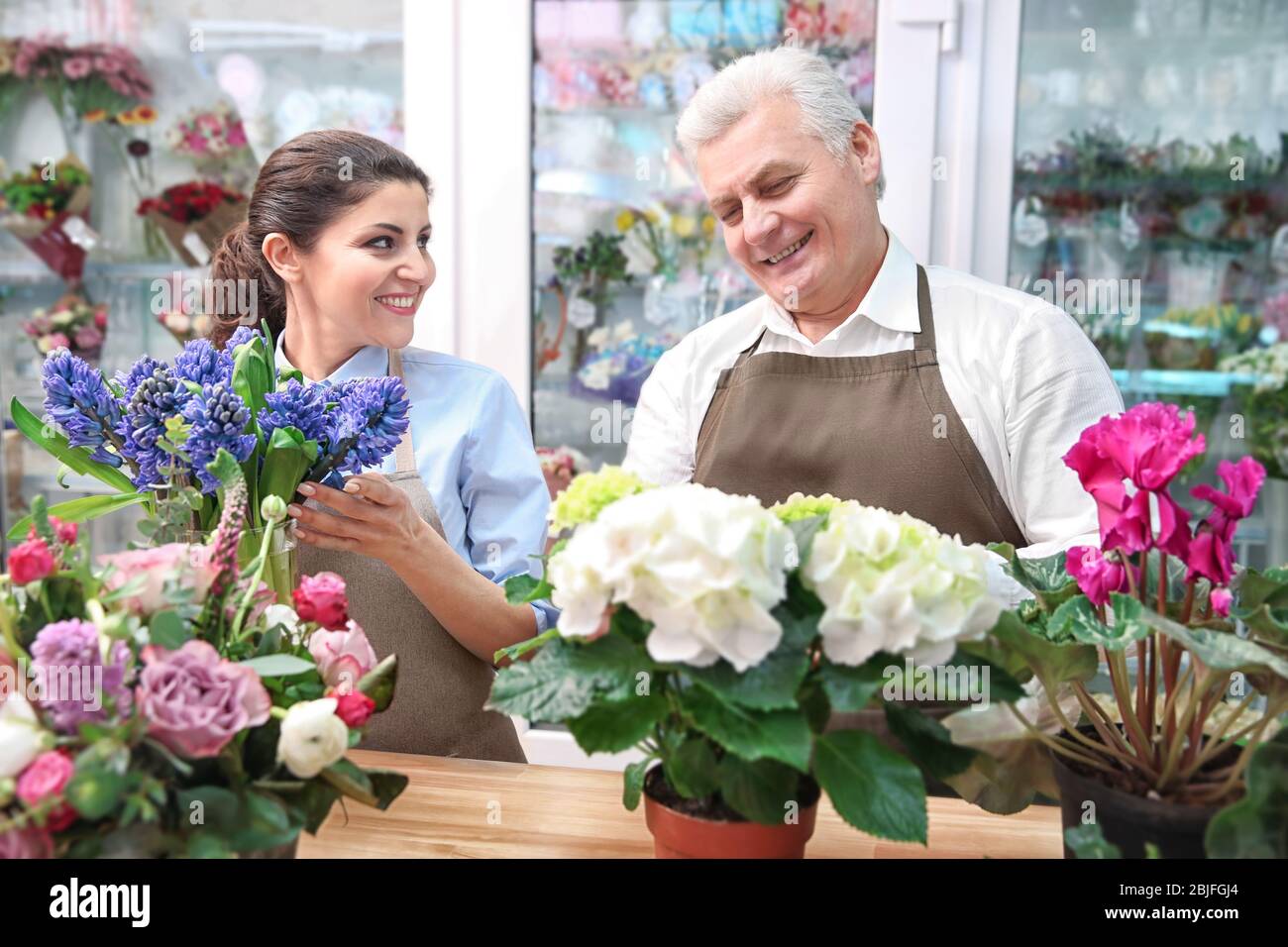 Male and female florists in flower shop Stock Photo