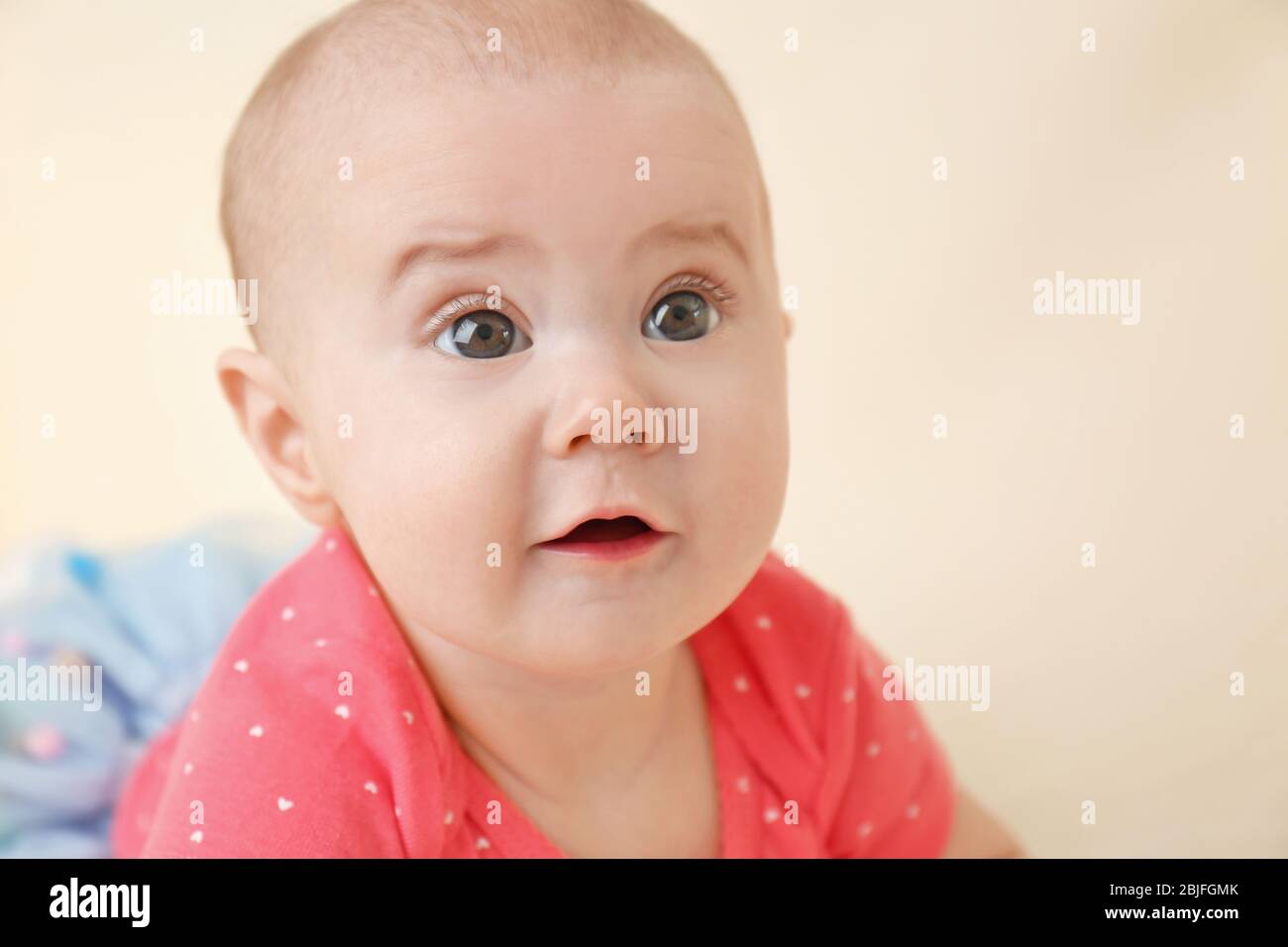 Portrait of adorable baby on light background Stock Photo - Alamy