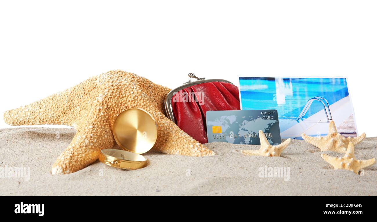 Sand with credit card, starfish and wallet on white background Stock Photo