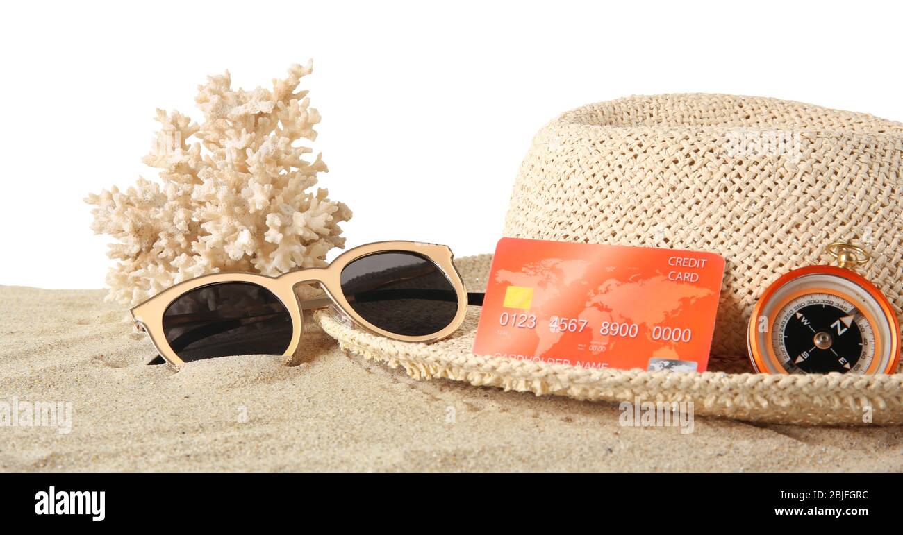 Sand with credit card and hat on white background Stock Photo
