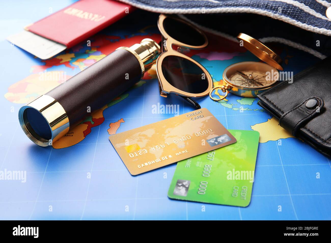Credit cards with spyglass on world map background Stock Photo