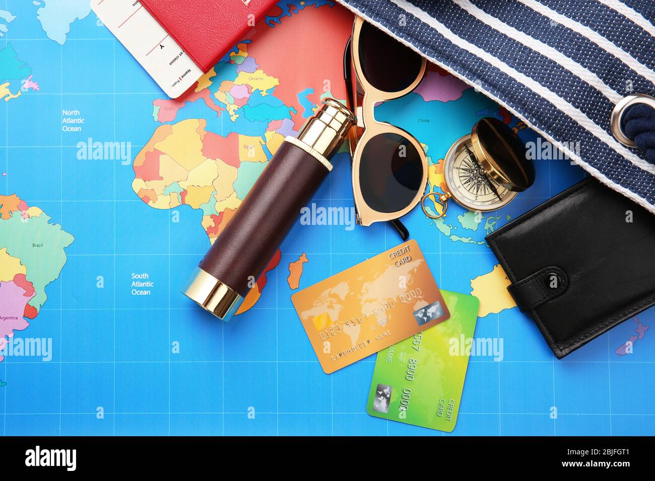 Credit cards with spyglass on world map background Stock Photo