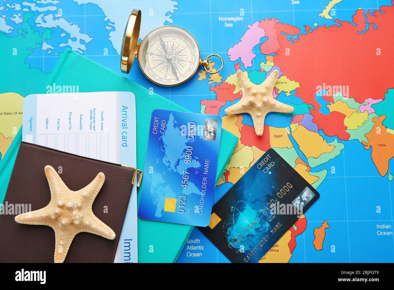Credit cards with passport and ticket for vacations on world map background Stock Photo
