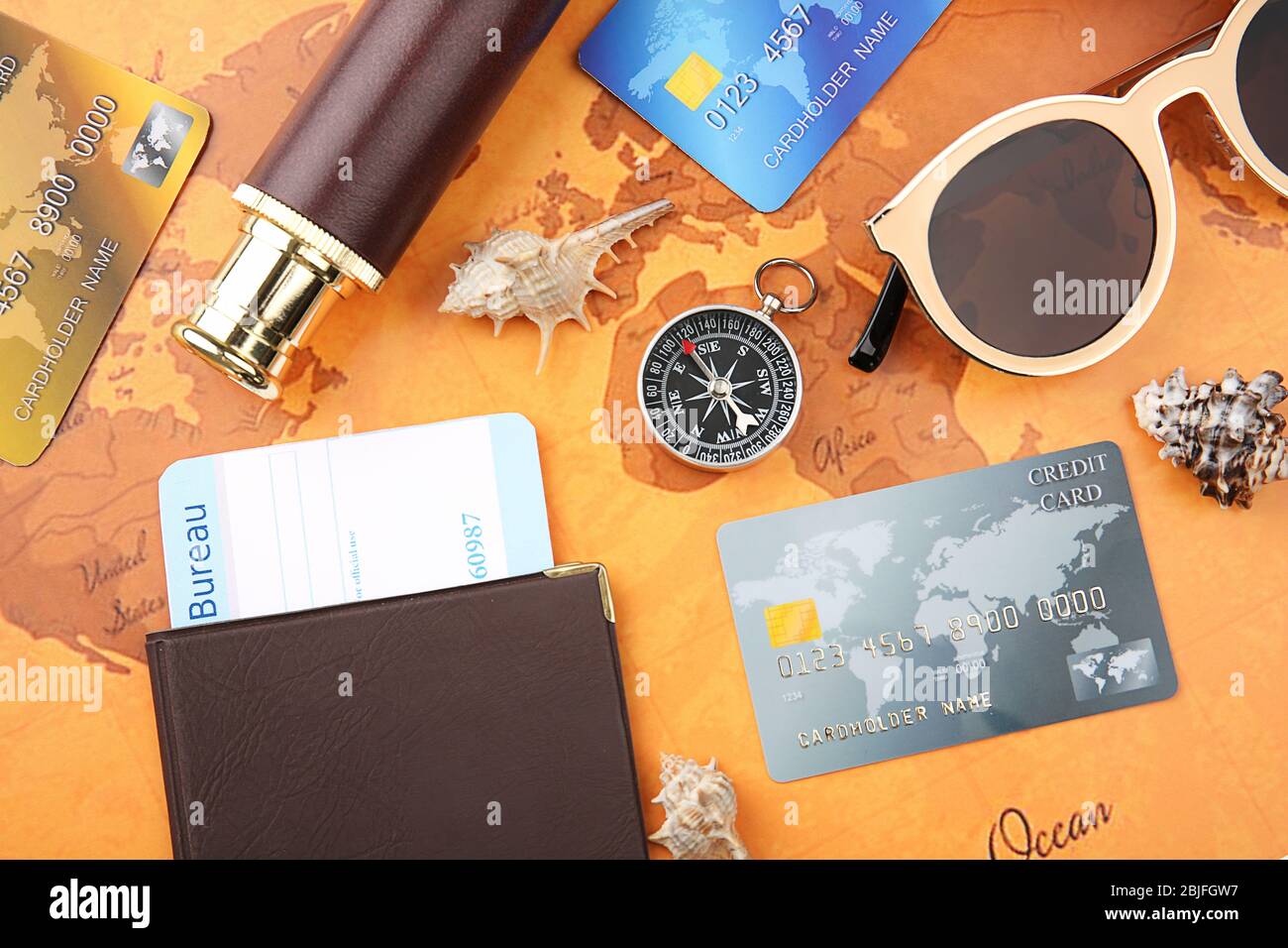 Credit cards with passport and ticket for vacation on world map background Stock Photo
