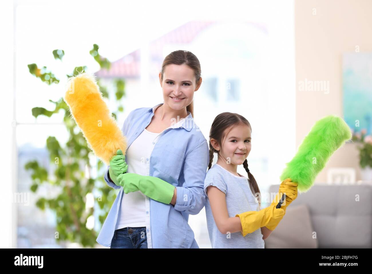 Mother and daughter with cleaning tools at home Stock Photo Alamy