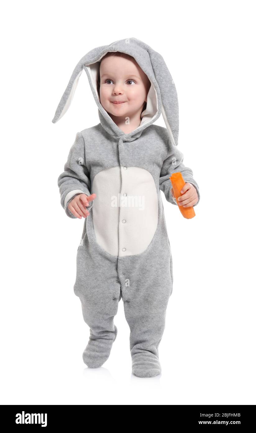 Cute little baby in bunny costume with carrot on white background Stock