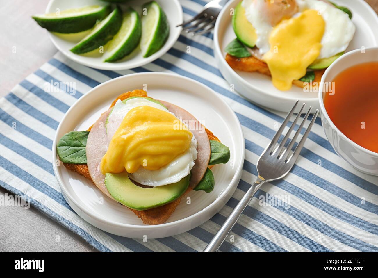 Plates with tasty eggs Benedict on table Stock Photo