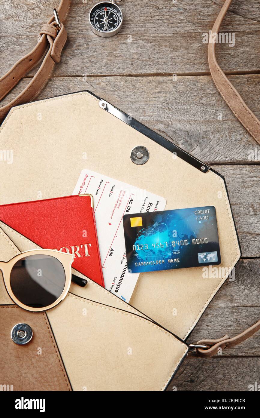 Credit card with bag and passport on wooden background Stock Photo
