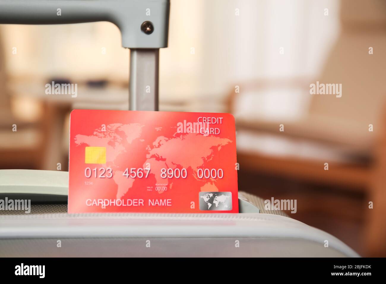 Credit card in suitcase on blurred background Stock Photo Alamy