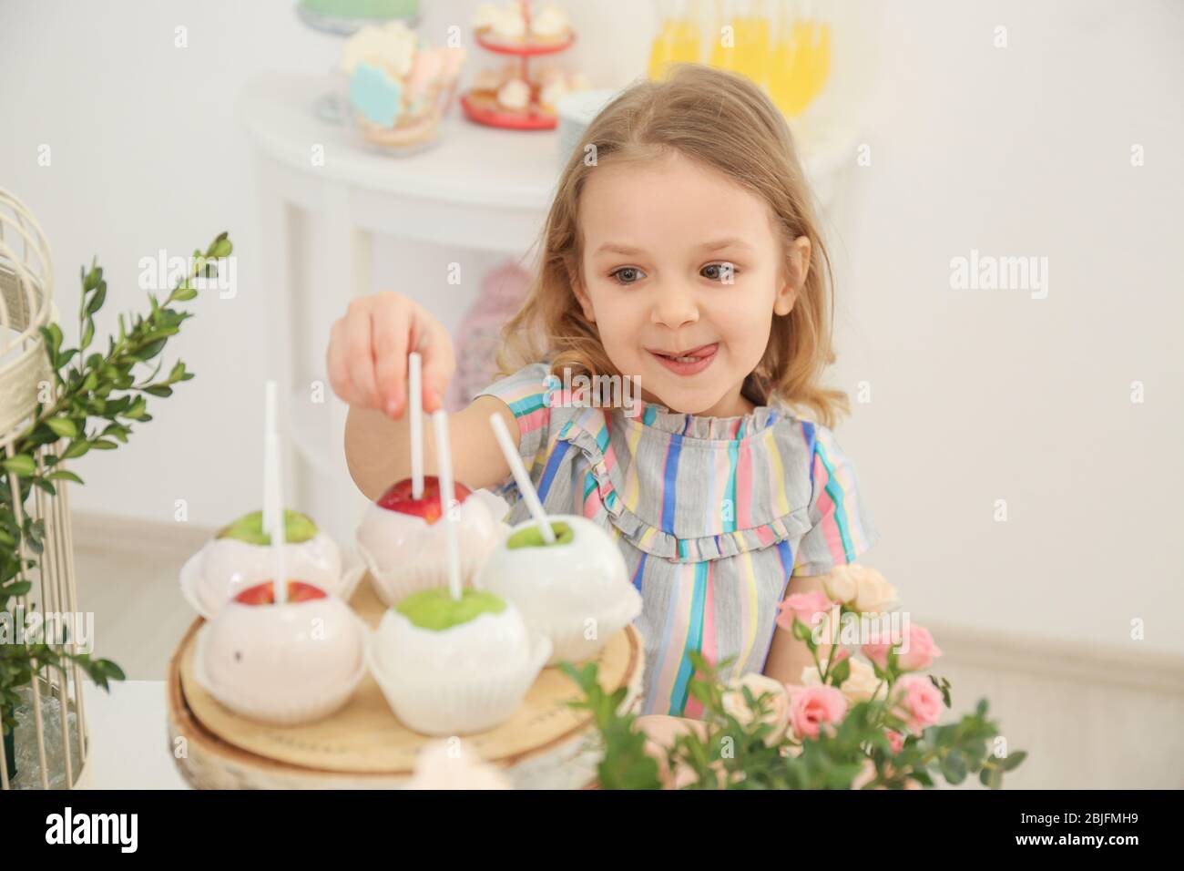 cute-girl-taking-sweets-served-for-party-stock-photo-alamy