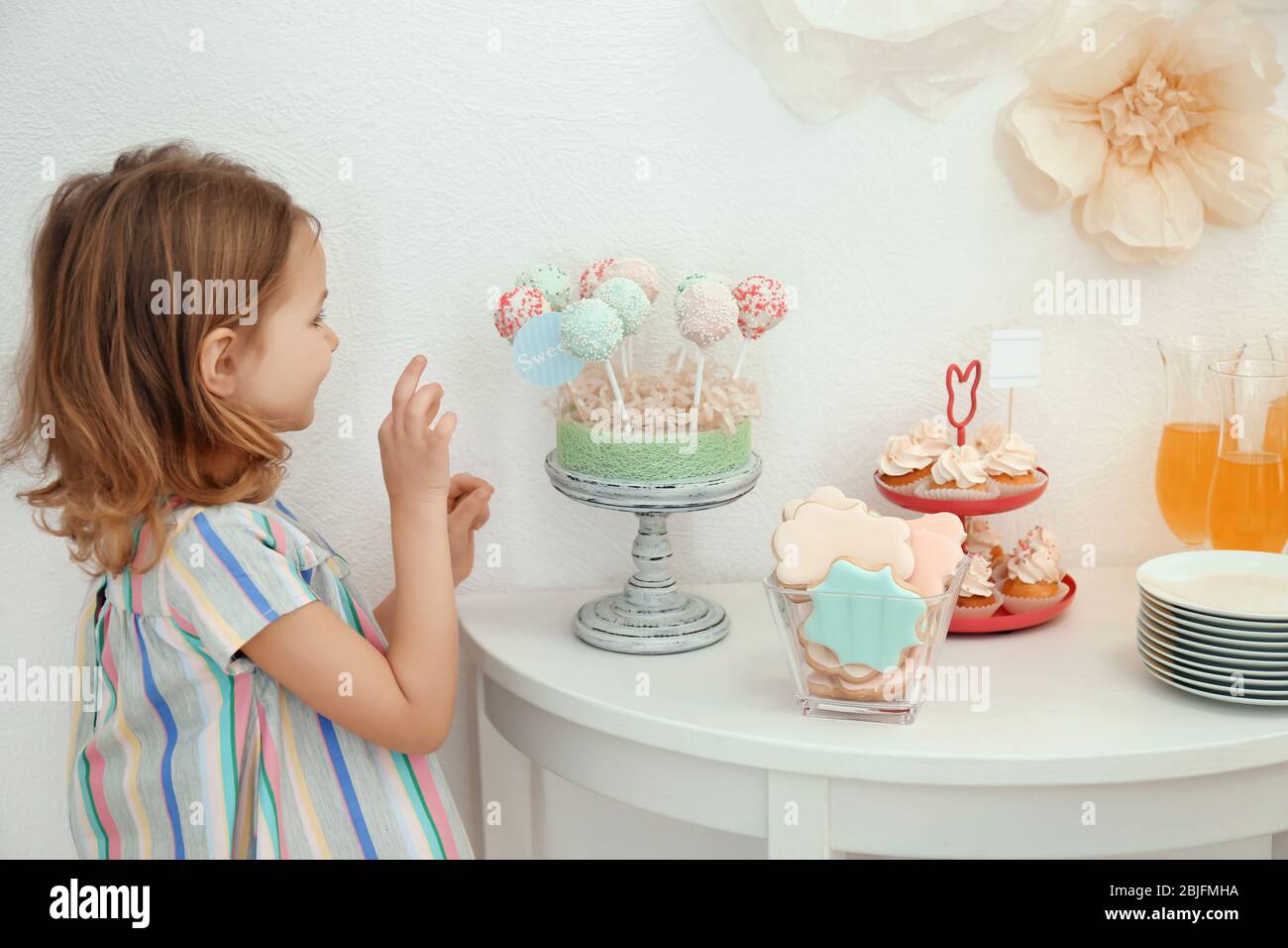 cute-girl-near-table-with-sweets-served-for-party-stock-photo-alamy