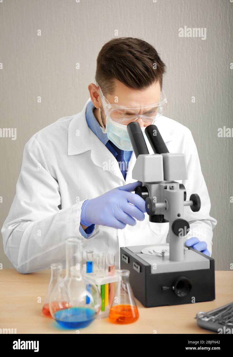Scientist looking light microscope hi-res stock photography and images ...