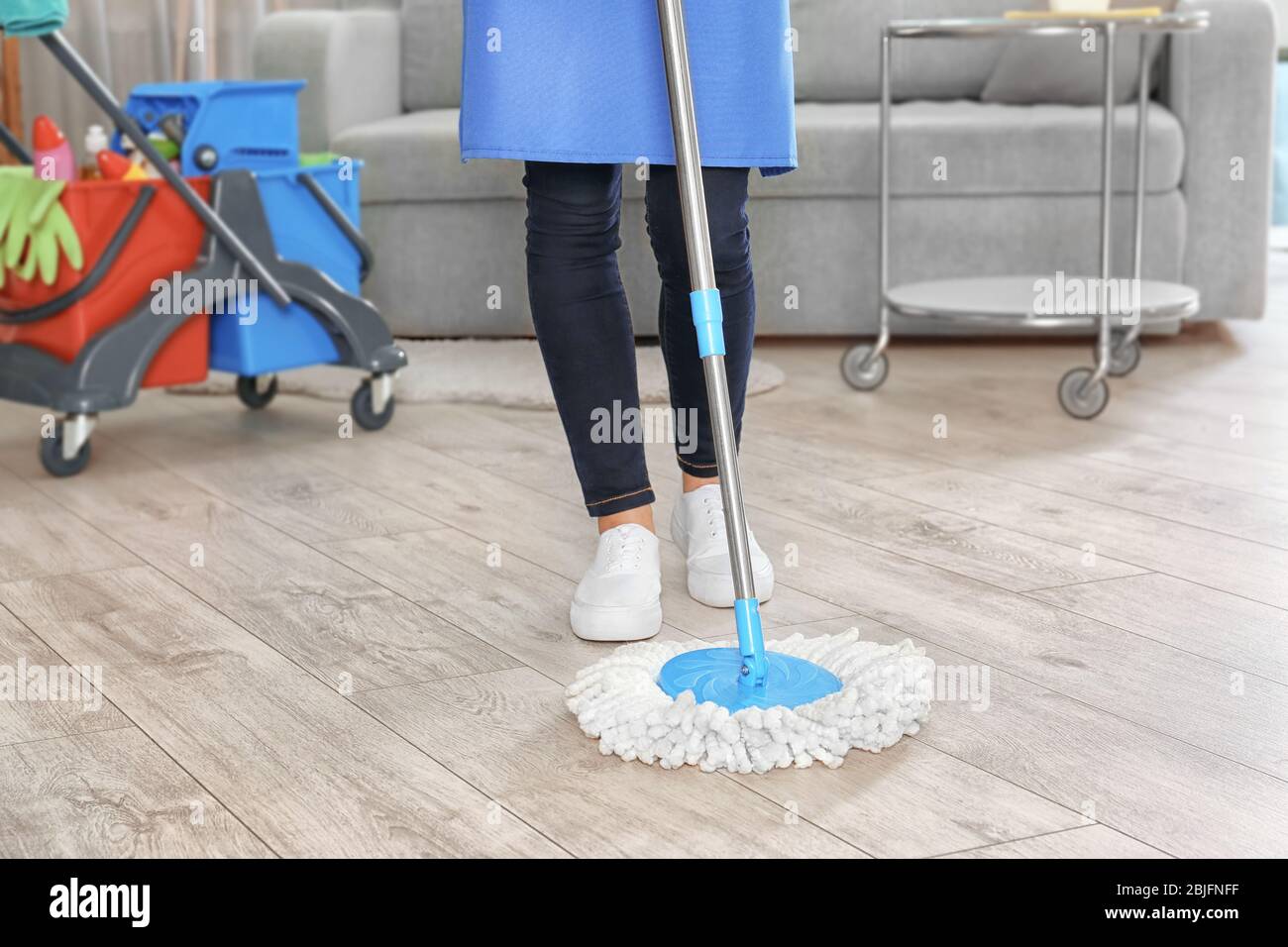 Woman mopping floor at home Stock Photo