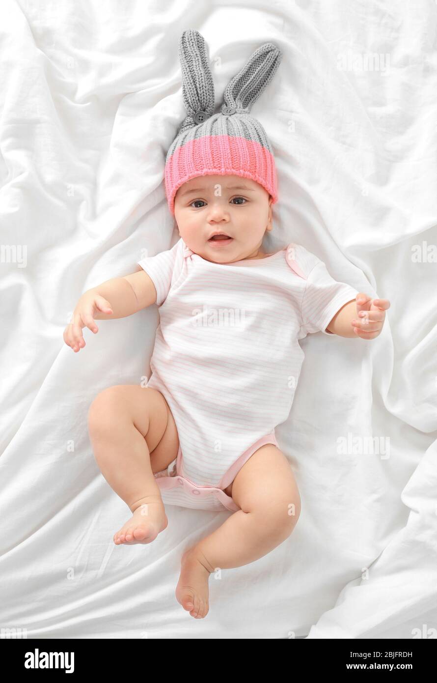 Cute little baby lying on bed at home Stock Photo - Alamy