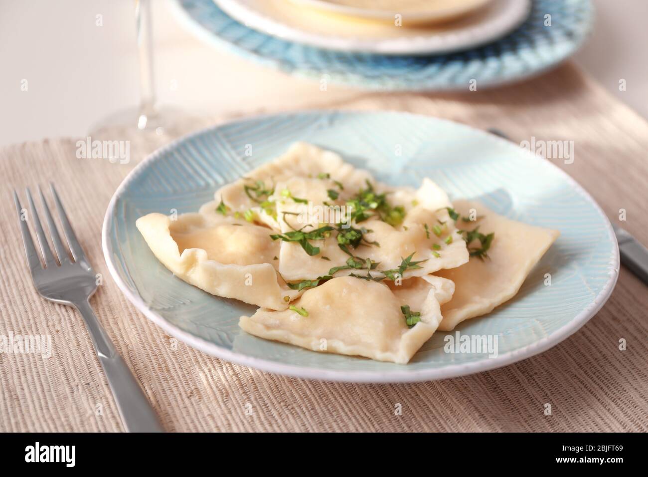 Plate with delicious ravioli on table Stock Photo - Alamy