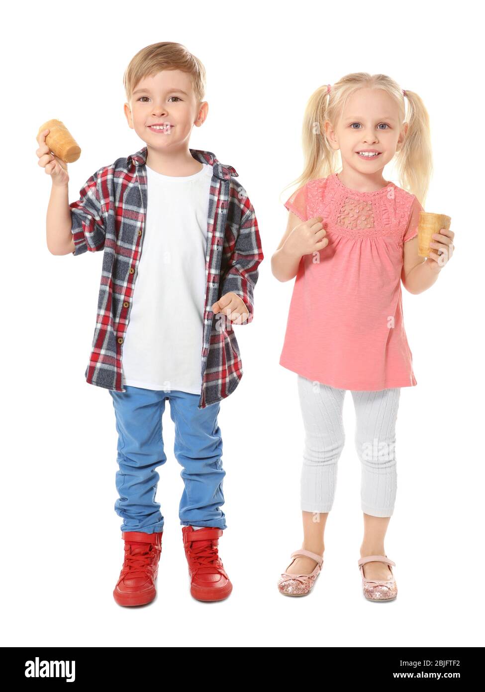 Cute little children eating ice cream on white background Stock Photo