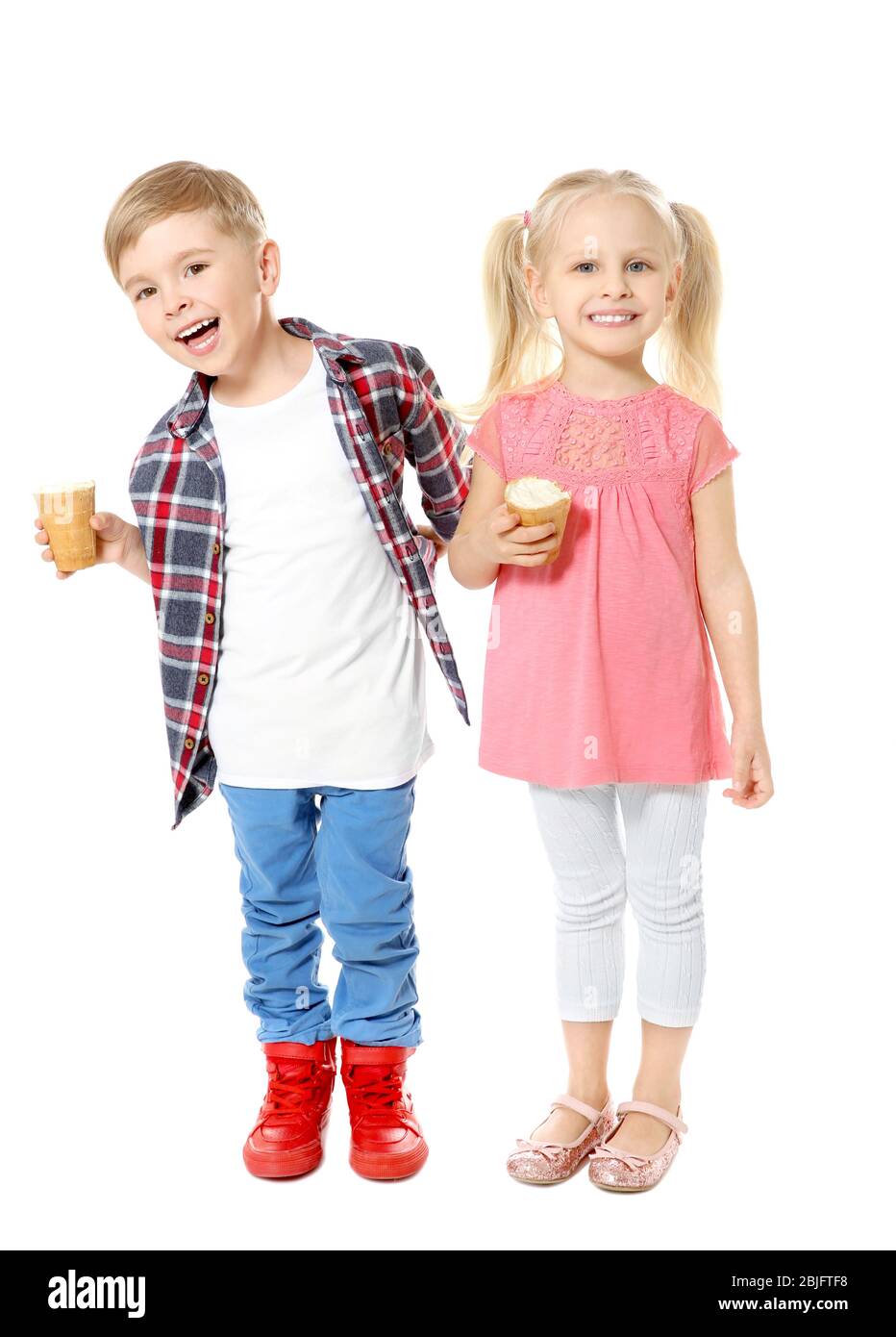 Cute little children eating ice cream on white background Stock Photo