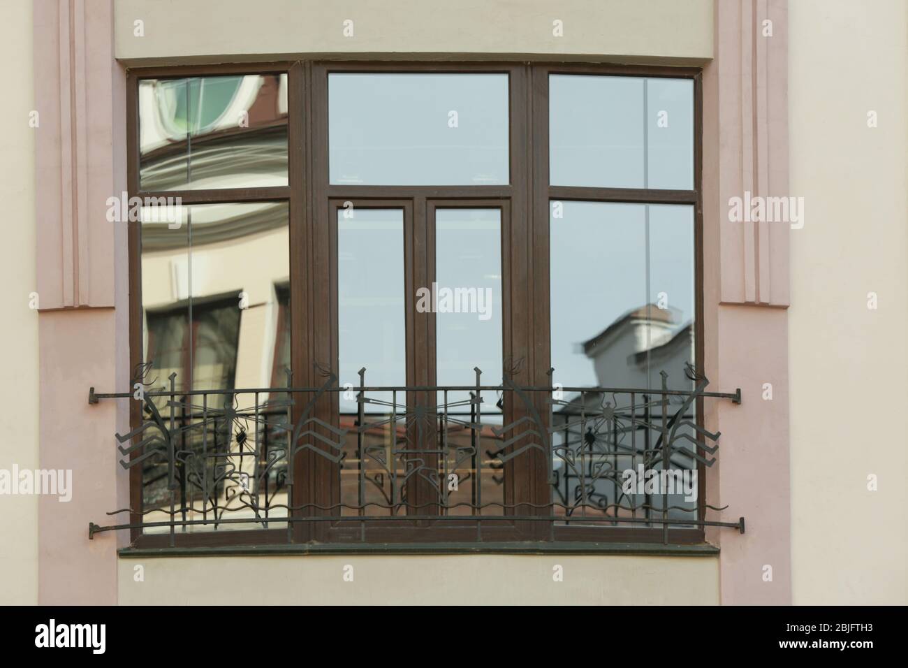 Brown plastic window with forging Stock Photo - Alamy