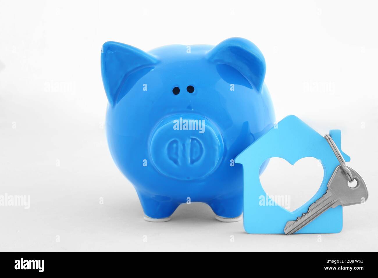 Savings concept. Piggy bank with key on white background Stock Photo ...