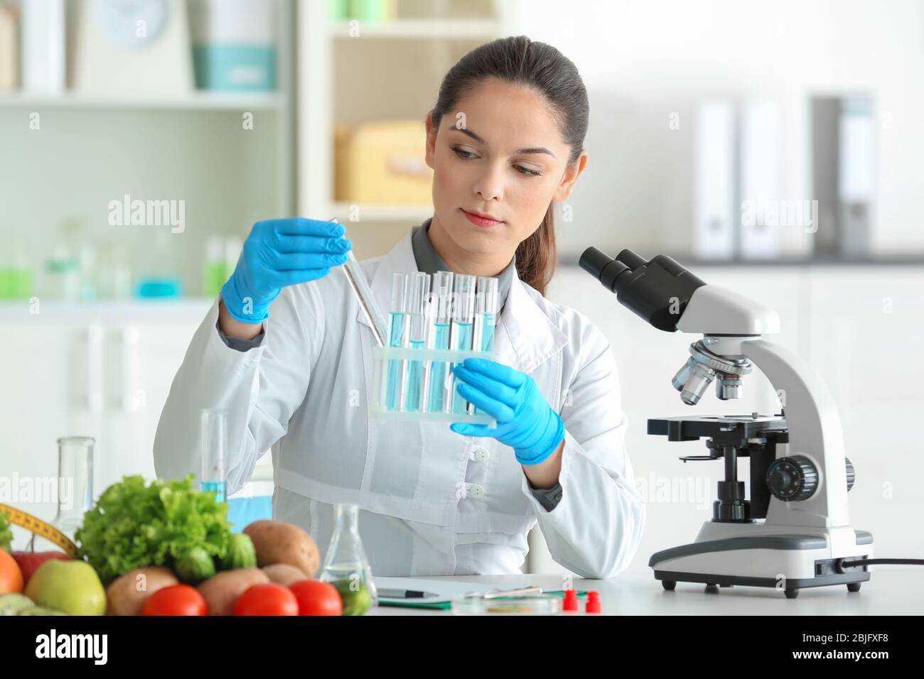 young-female-nutritionist-testing-food-samples-in-laboratory-stock-photo-alamy