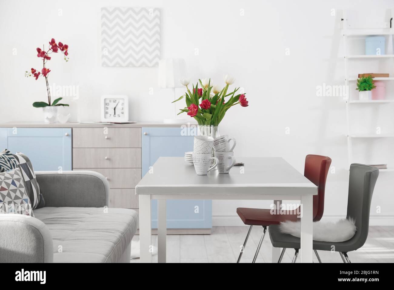 Modern living room with table and chairs Stock Photo - Alamy