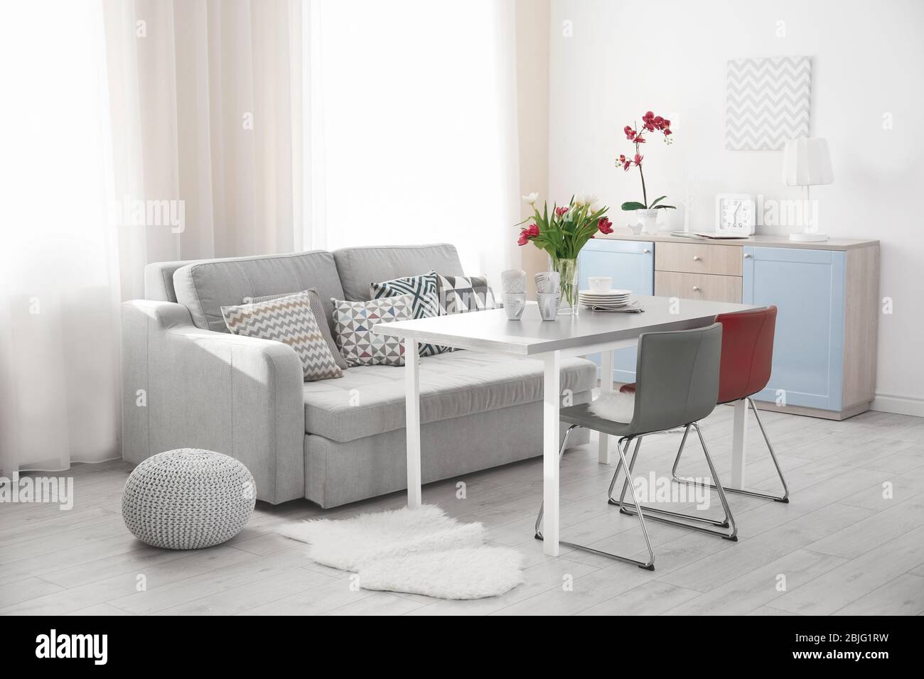 Modern living room with table and chairs Stock Photo - Alamy