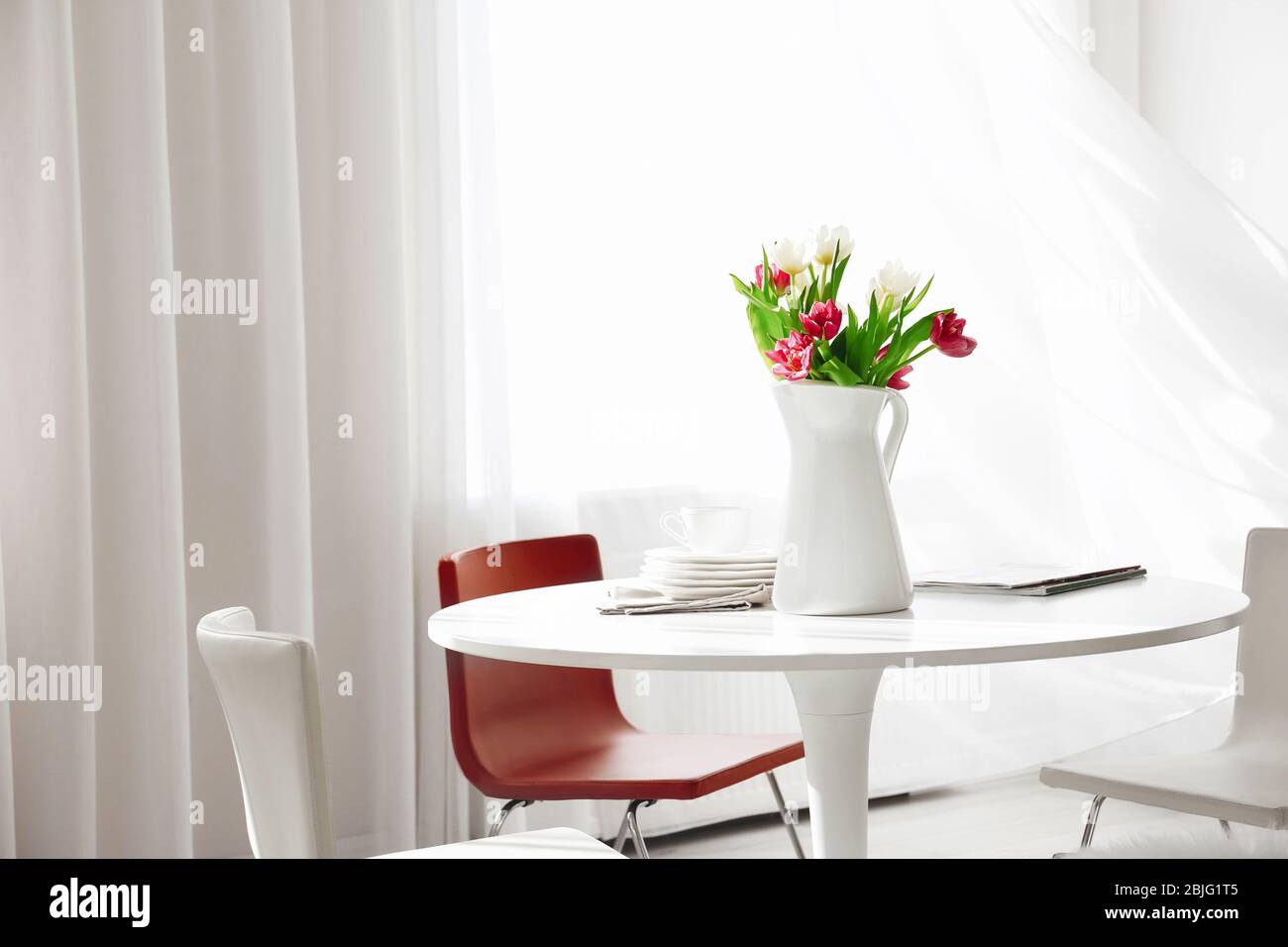 Modern living room with table and chairs Stock Photo - Alamy