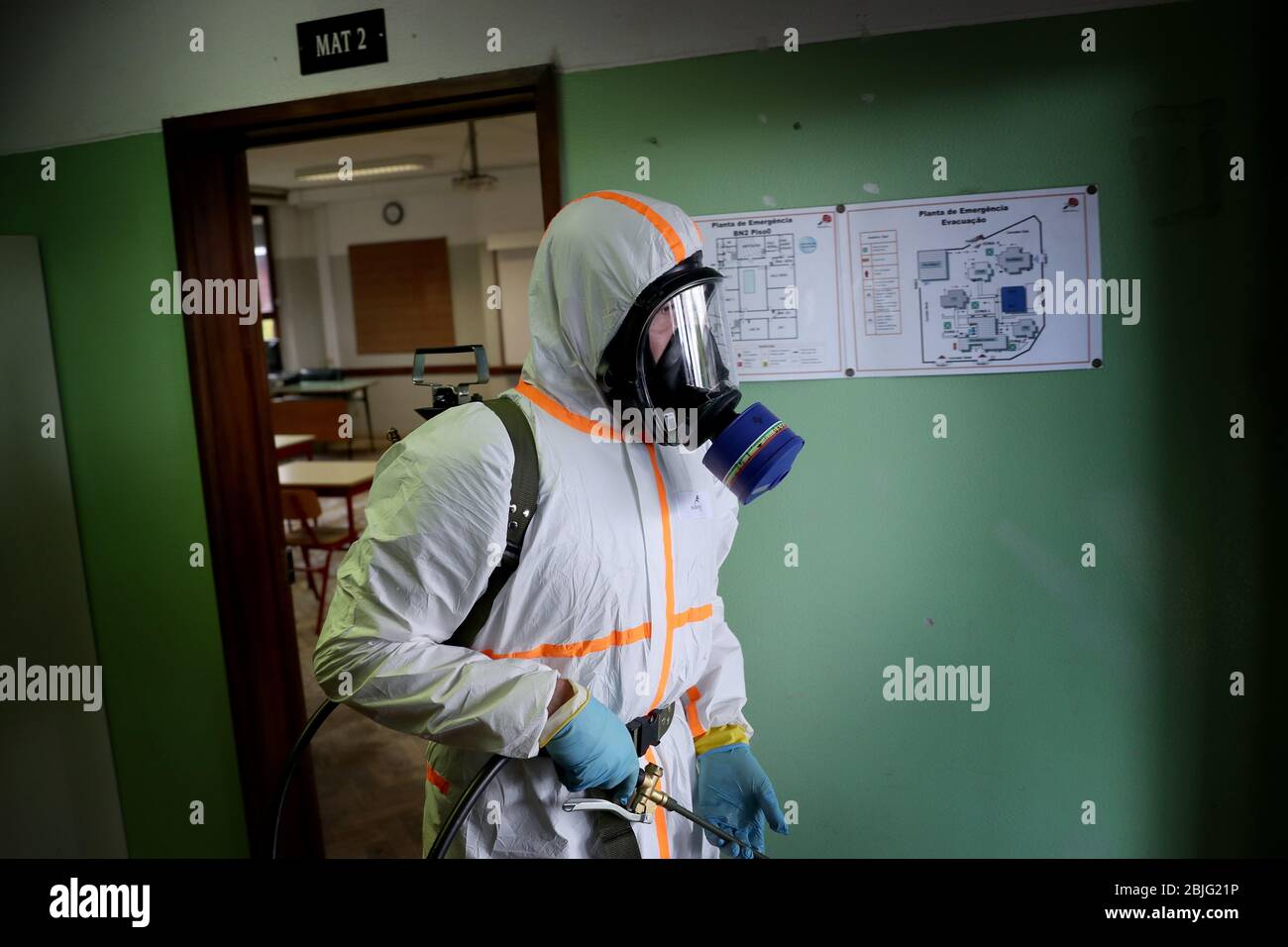 Lisbon, Portugal. 29th Apr, 2020. A Portuguese Soldier wearing protective gear disinfects a high school as the spread of the COVID-19 coronavirus disease continues, in Lisbon, Portugal on April 29, 2020. As Portugal's state of emergency will end on May 2 and the Government expected to reopen high schools in mid-May, more than 400 members of the country's armed forces are carrying out the disinfection of schools. Credit: Pedro Fiuza/ZUMA Wire/Alamy Live News Stock Photo