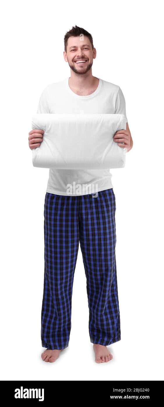 Young happy man in pajamas holding orthopedic pillow on white background Stock Photo Alamy