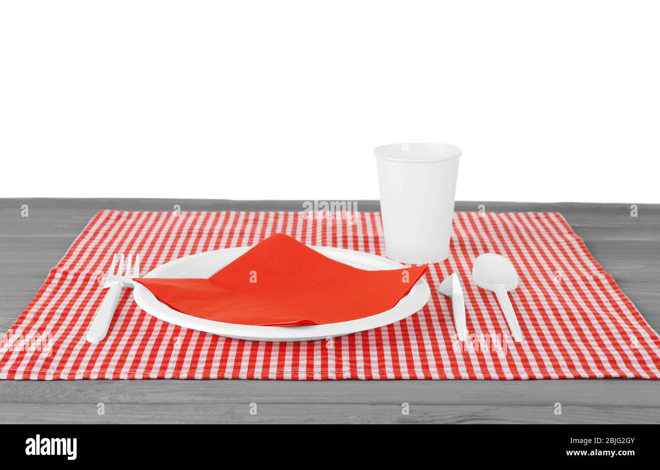 White plastic disposable tableware on wooden table Stock Photo