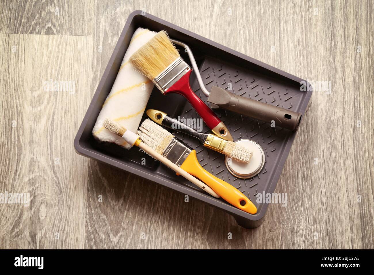 Set of tools for painting on floor Stock Photo - Alamy