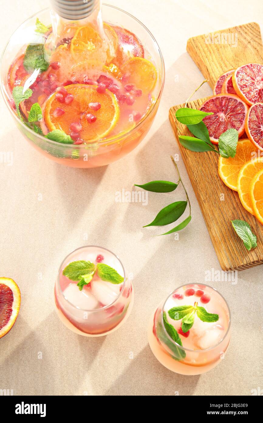 Two glasses of fresh cocktail with pomegranate and orange on table ...