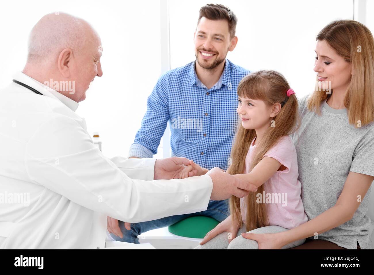 Little girl with parents at doctor's office Stock Photo
