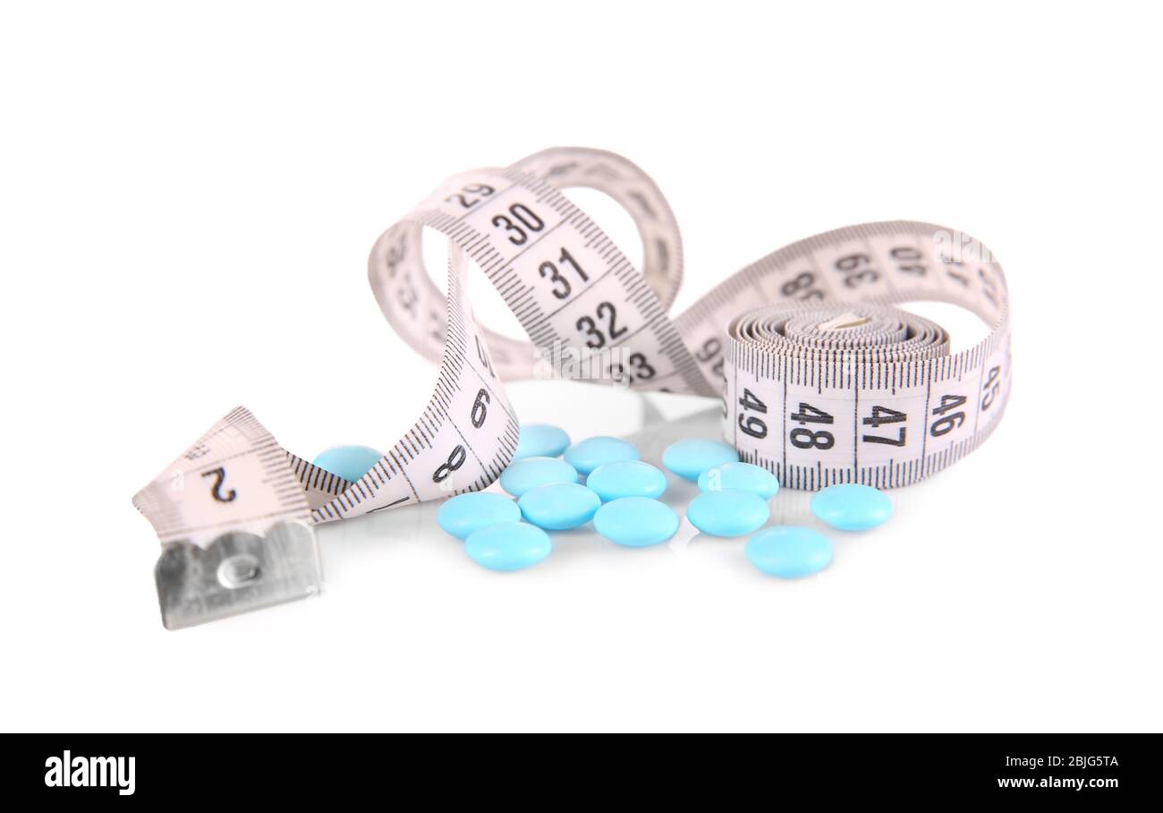 Diet concept. Measuring tape and pills on white background Stock Photo ...