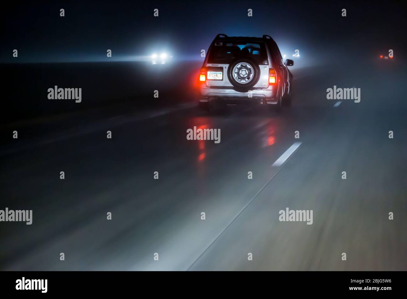 Driving during rainy, foggy condidtions at night along Interstate 90 in in Minnesota, USA [No property release; available for editorial licensing only Stock Photo