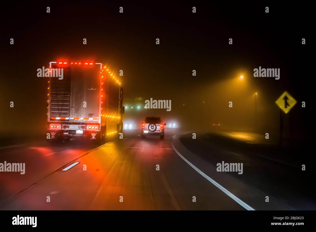 Driving during rainy, foggy condidtions at night along Interstate 90 in in Minnesota, USA [No property release; available for editorial licensing only Stock Photo